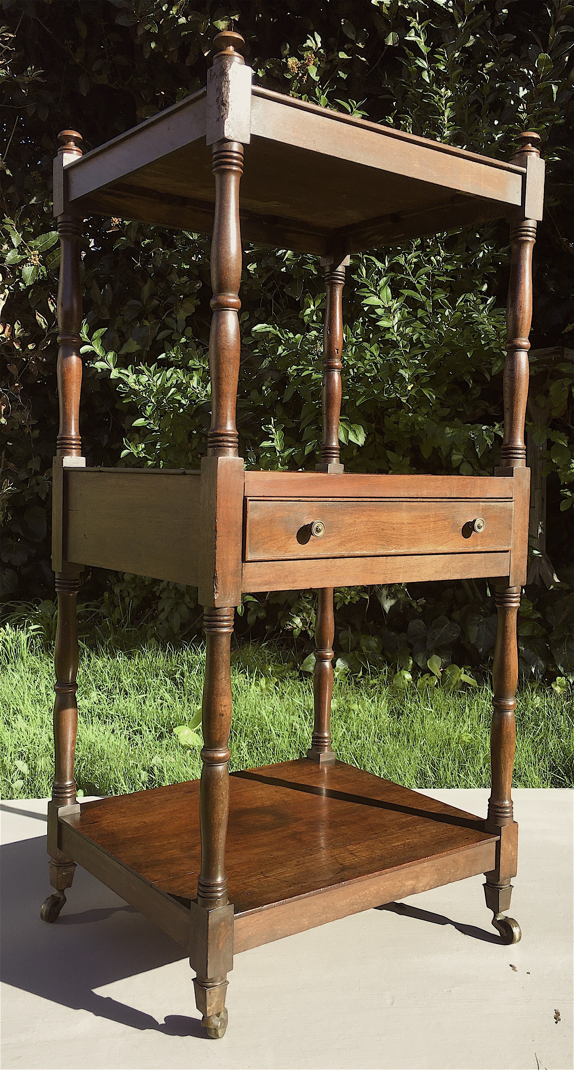 A Regency mahogany three tier whatnot fitted mid drawer, width 46cm, depth 38cm, height 98cm.